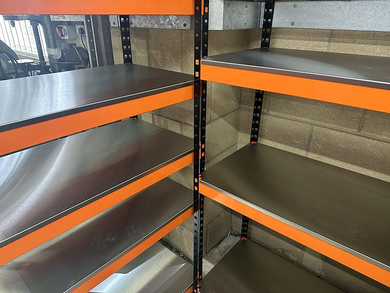 New orange and black click together racking with steel shelves in the Vale workshop